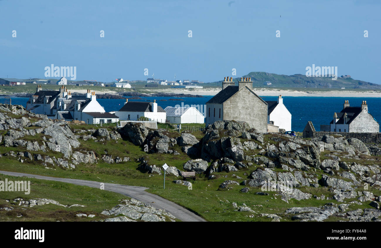 Tiree Inner Hebrides, rocky shoreline and the village of Mannal Isle of Tiree, Inner Hebrides, Scotland GB Stock Photo