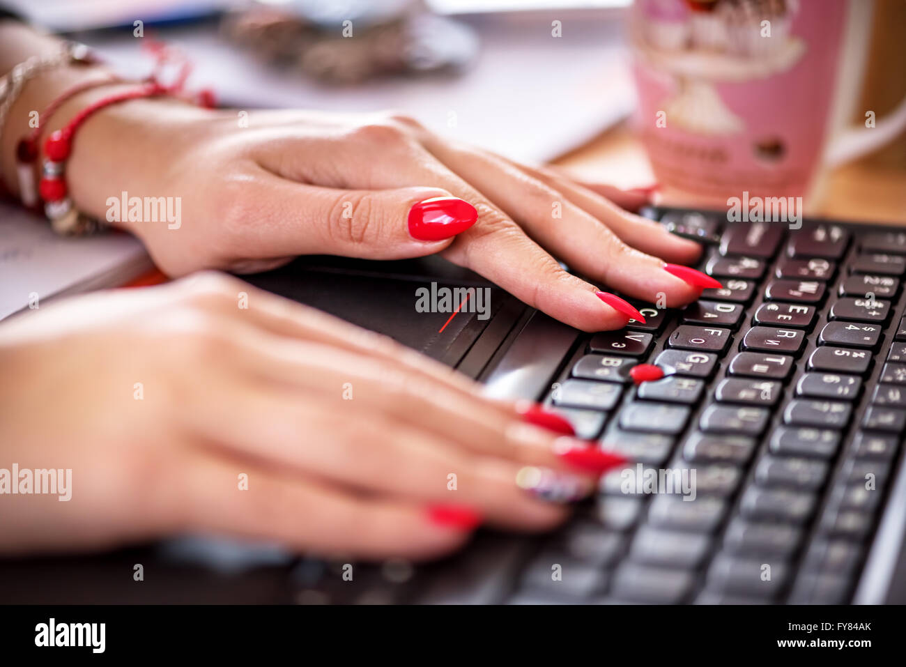 Female office worker typing on the keyboard. Stock Photo