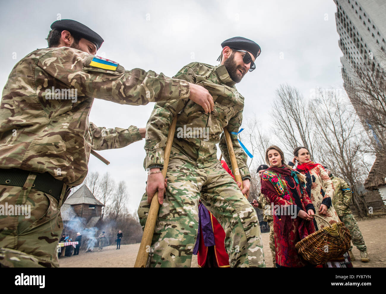 Soldiers of Georgia National Legion (part of Armed Forces of Ukraine) take part in traditional games during Maslenitsa festivities in Mamayeva Sloboda, Kyiv, Ukraine (Photo by Oleksandr Rupeta) Stock Photo