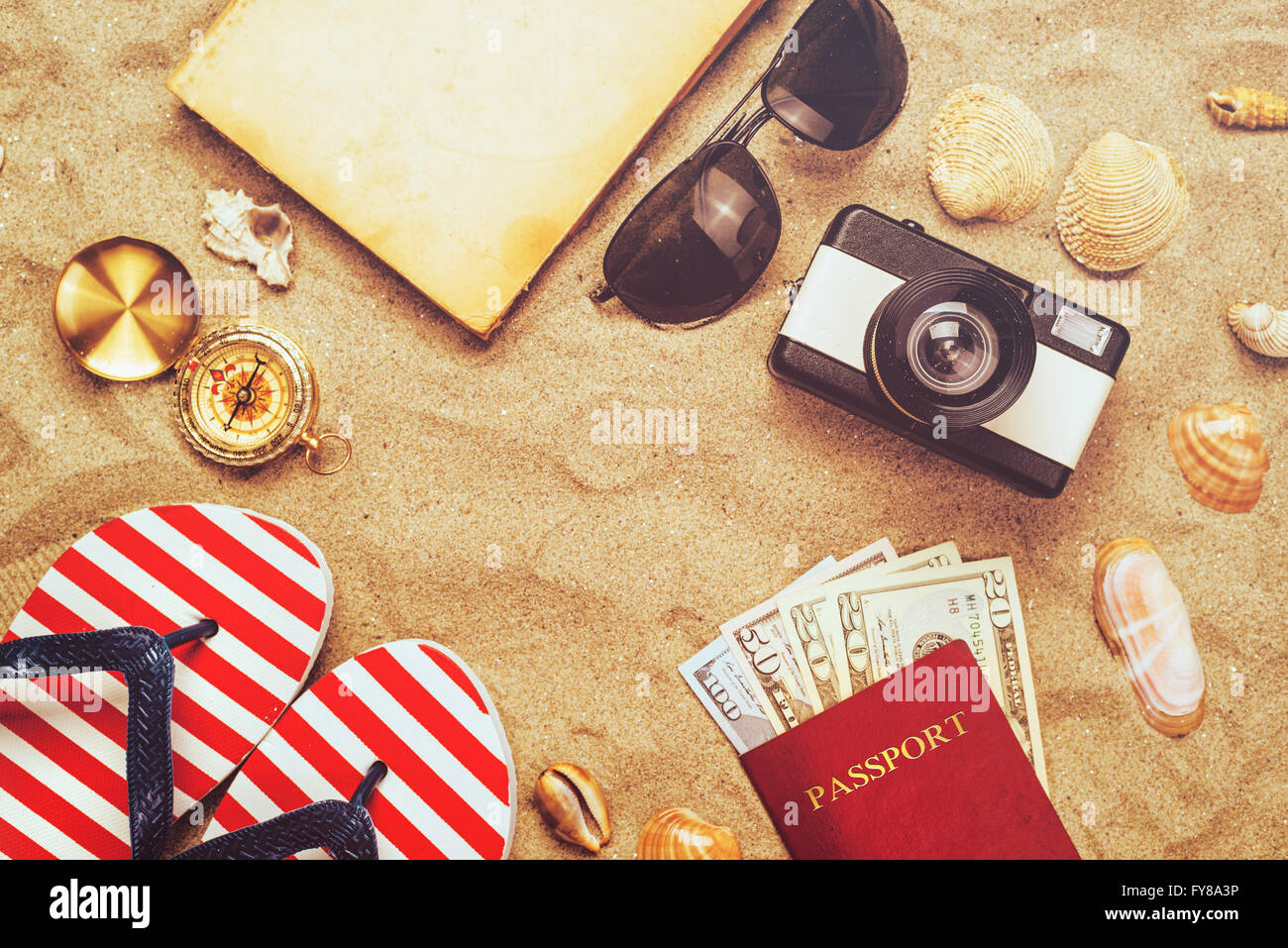 Summer vacation accessories on tropical sandy ocean beach, holidays abroad - summertime lifestyle objects and US American dollar Stock Photo