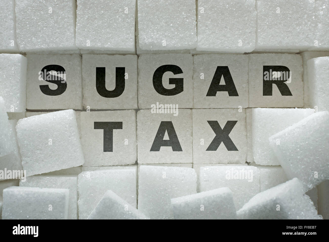 Sugar cubes and 'sugar tax' inscription Stock Photo