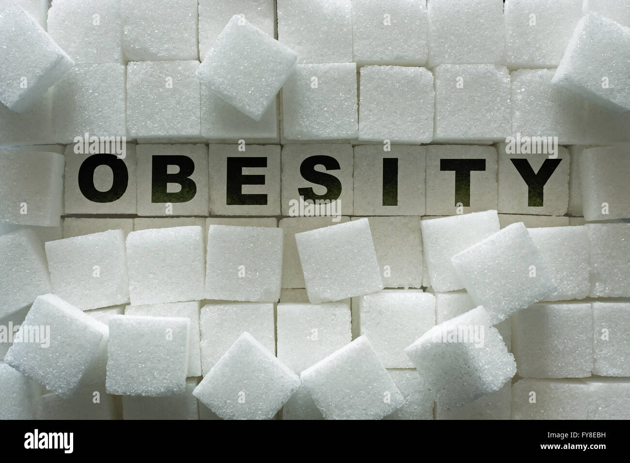 Sugar cubes and 'obesity' inscription Stock Photo