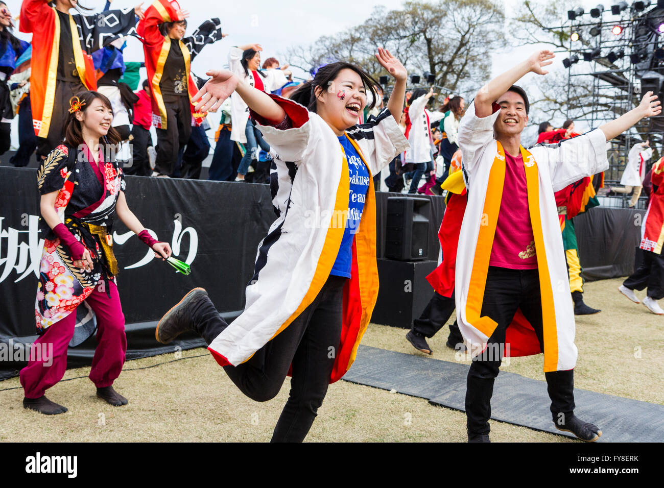 Japanese dance troupe, in traditional long yukata jackets, dancing on and in front of open-air stage during the yearly Yosakoi festival at Kumamoto. Stock Photo