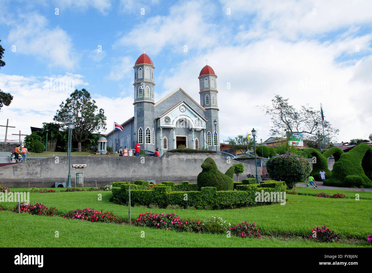 Zarcero, Costa Rica - November 23, 2015: The Francisco Alvardo Park with its famous topiary and the colorful catholic church of  Stock Photo