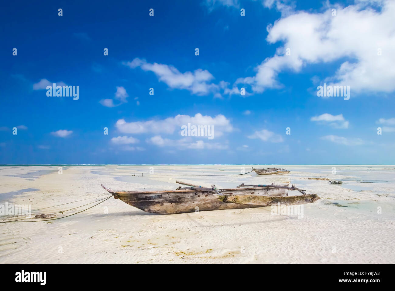 Dhow wooden fish boat lays dry during low tide on a beach at the Indian ...