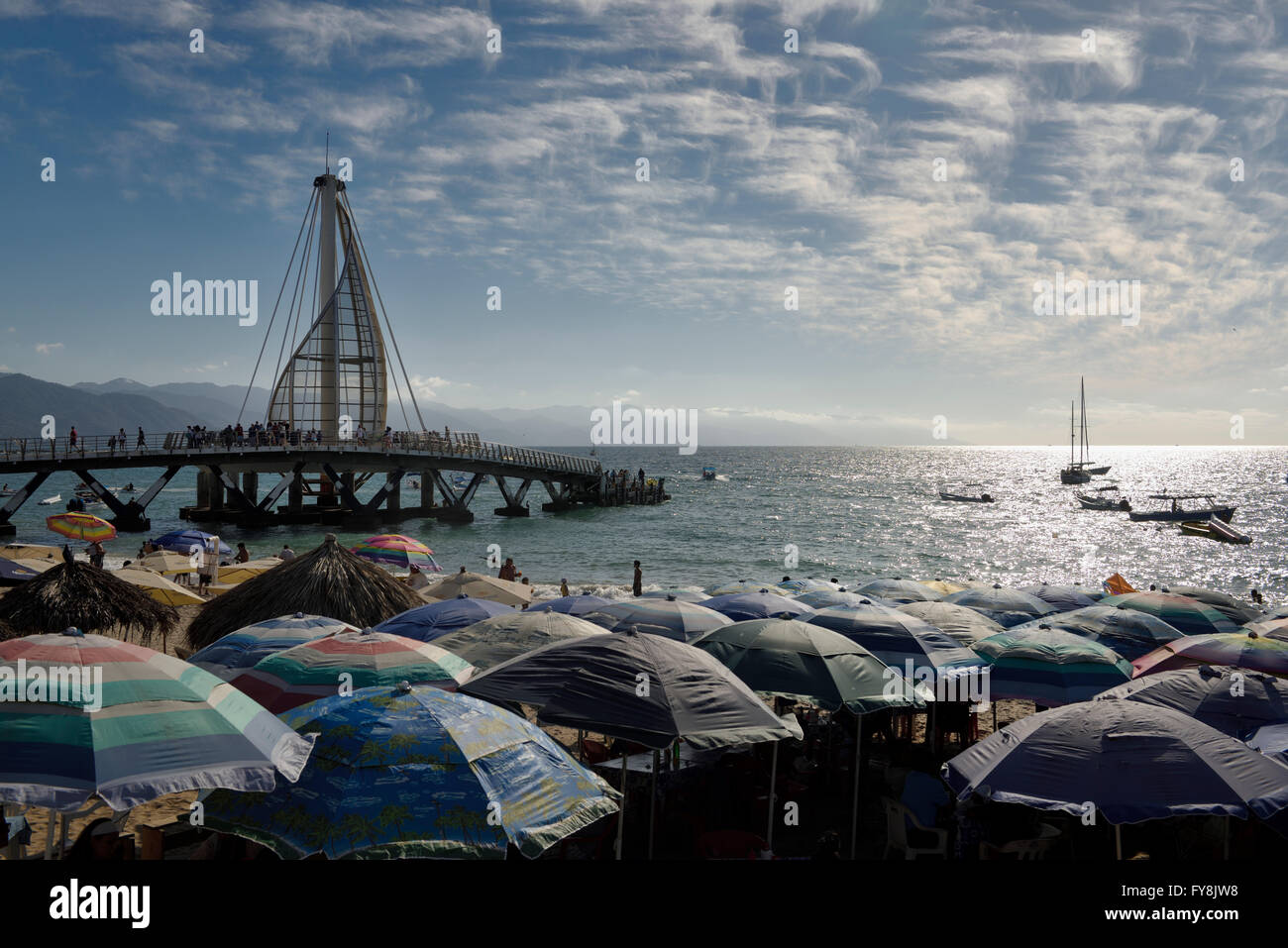 Beach umbrellas on Los Muertos beach at the Pier and Sierra Madre