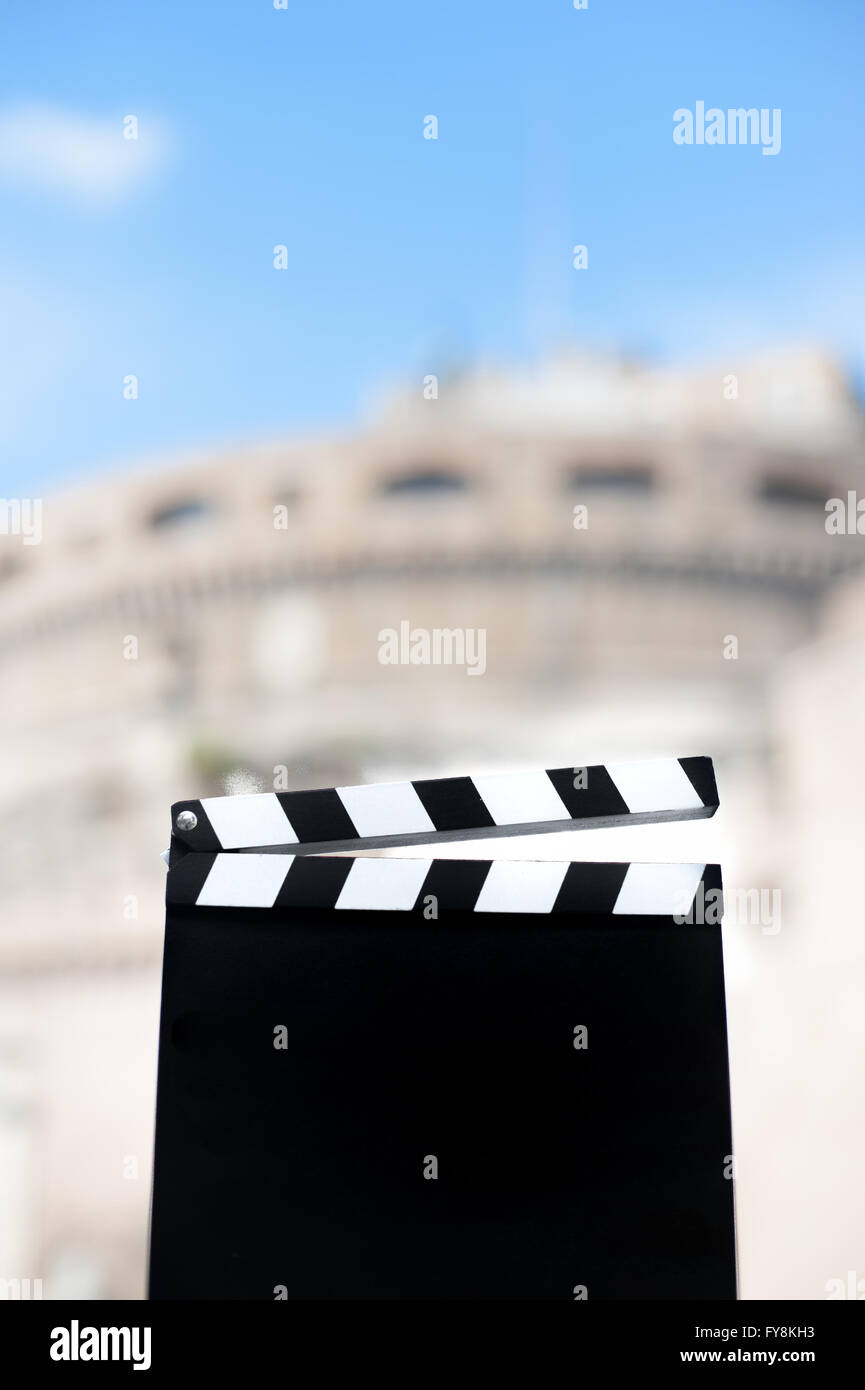 Movie clapper board with Castel Sant Angelo view out of focus in background Stock Photo