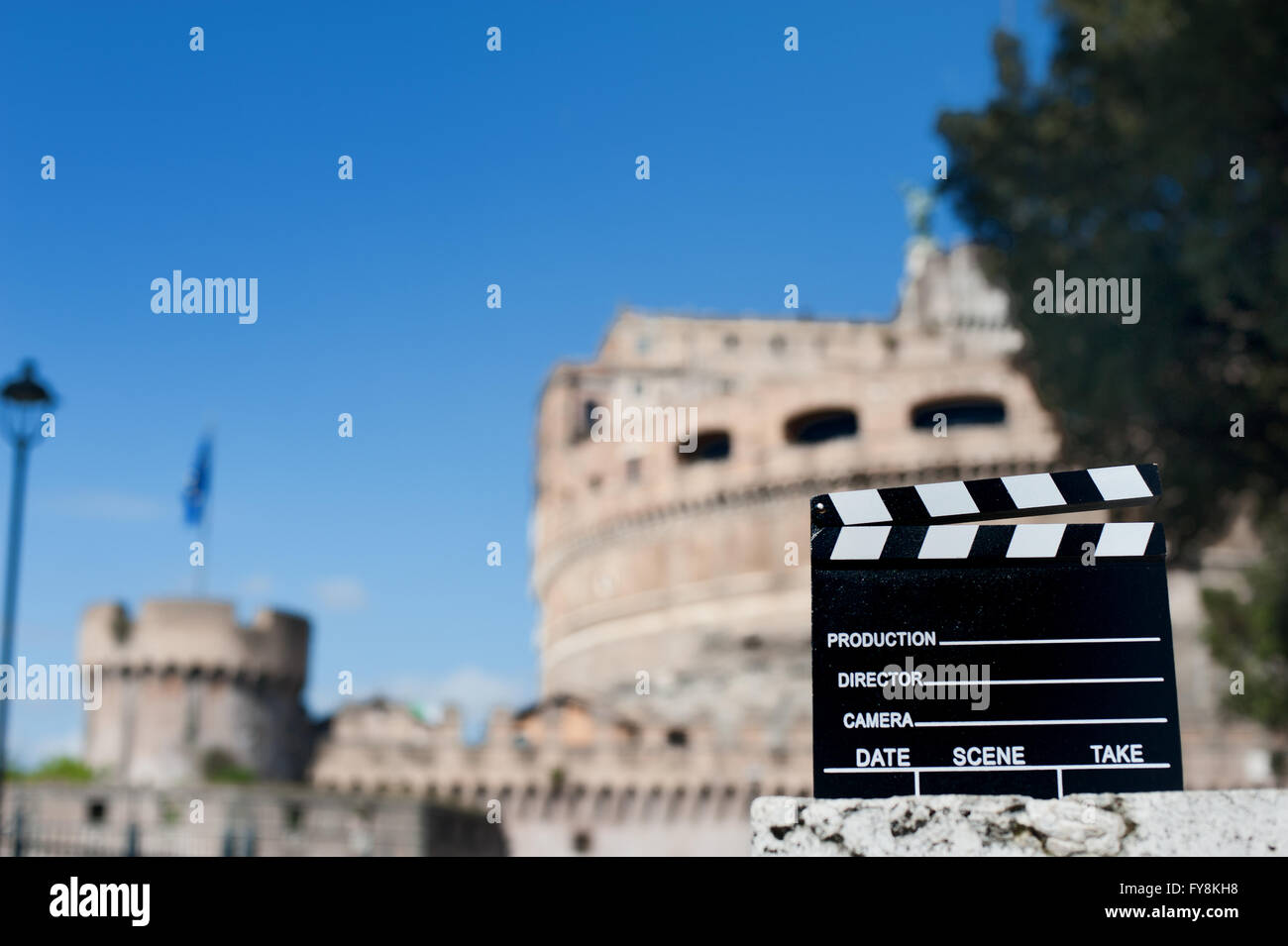 Movie clapper board with Castel Sant Angelo view out of focus in background Stock Photo