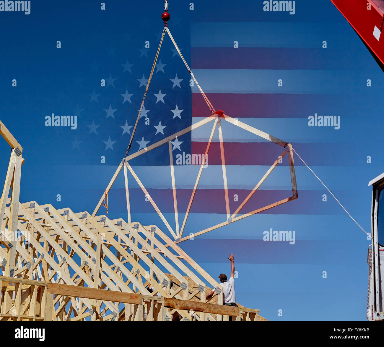Man carpenter reaching for roof truss USA flag American Jobs concept photograph Stock Photo
