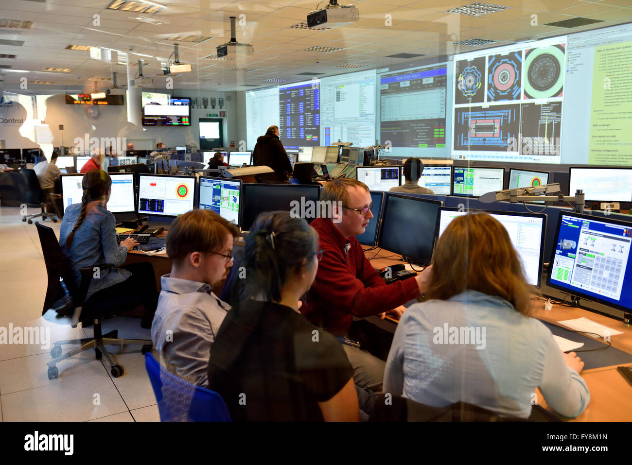 Inside the ATLAS building control room at CERN where physicists and students control detectors used to discover the Higgs boson. Stock Photo