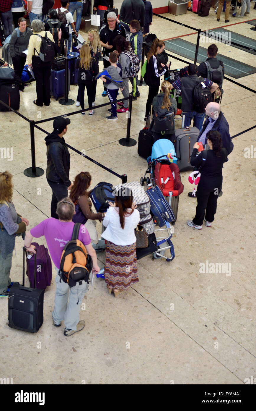 Line of passengers at airport check in Stock Photo
