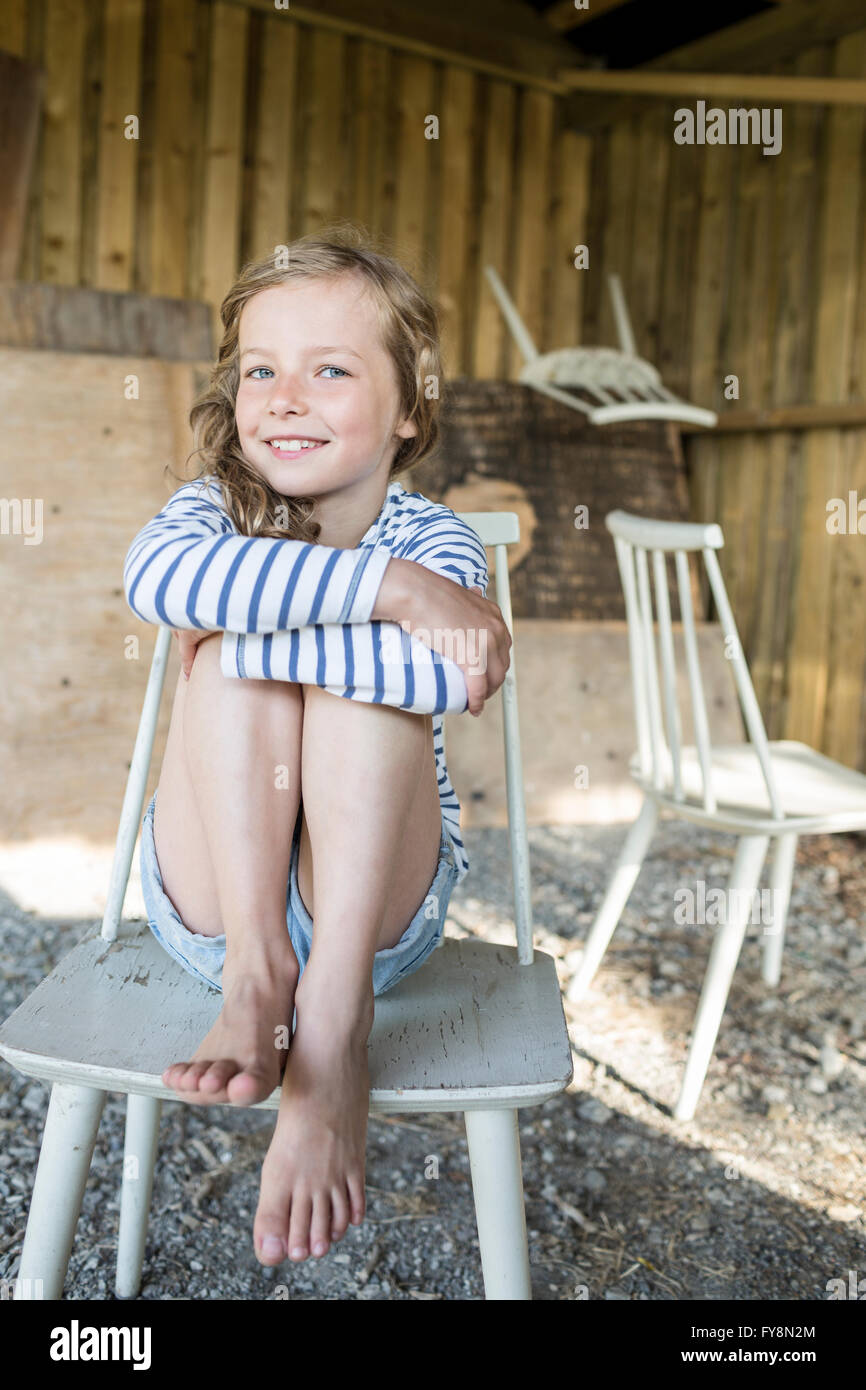 Portrait girl sitting hugging knees hi-res stock photography and images ...