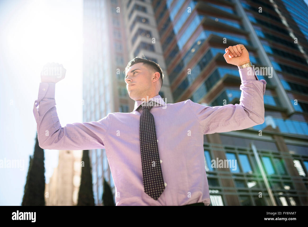 Confident businessman outdoors raising his arms Stock Photo - Alamy