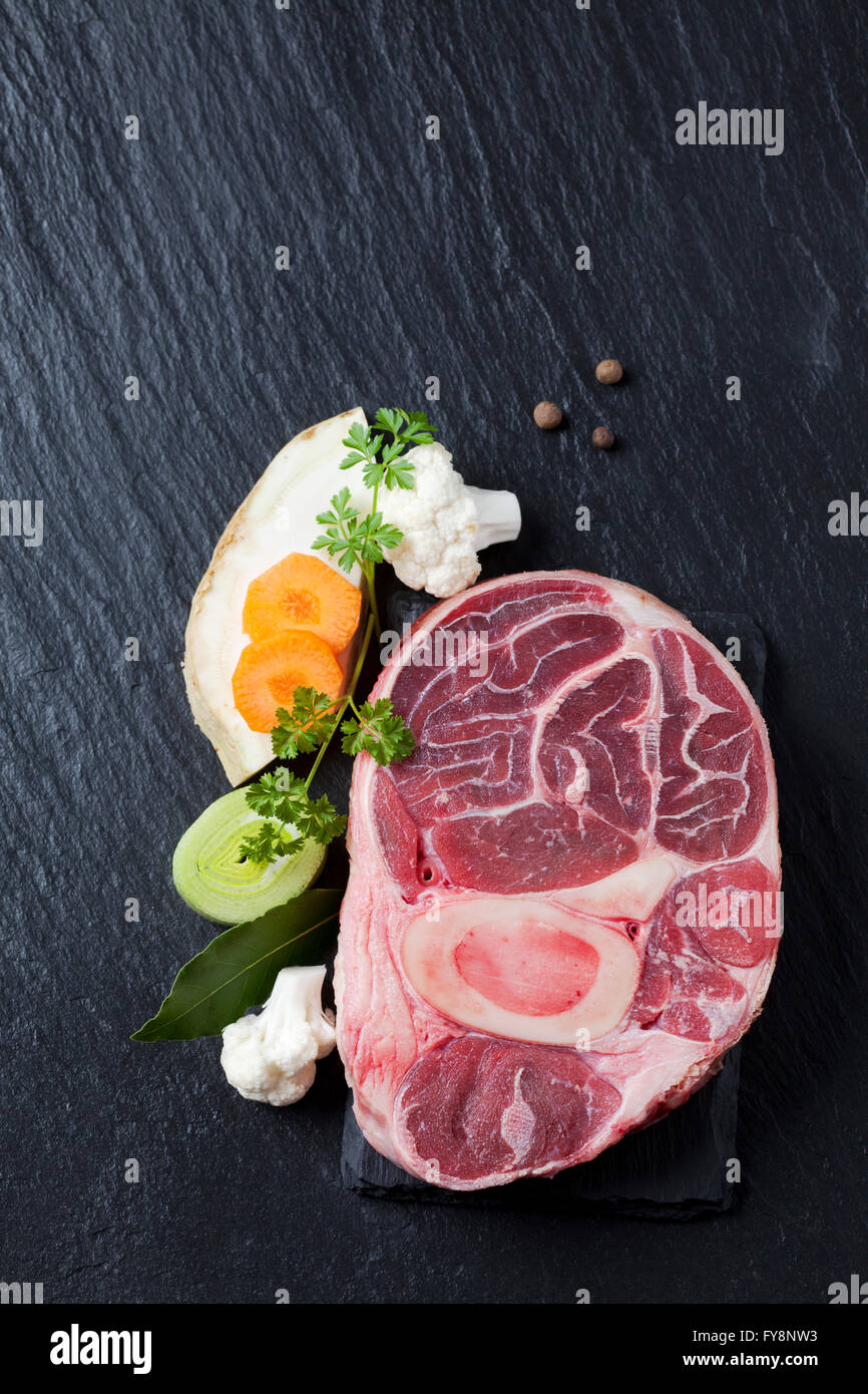 Raw beef shank with vegetables and herbs Stock Photo Alamy