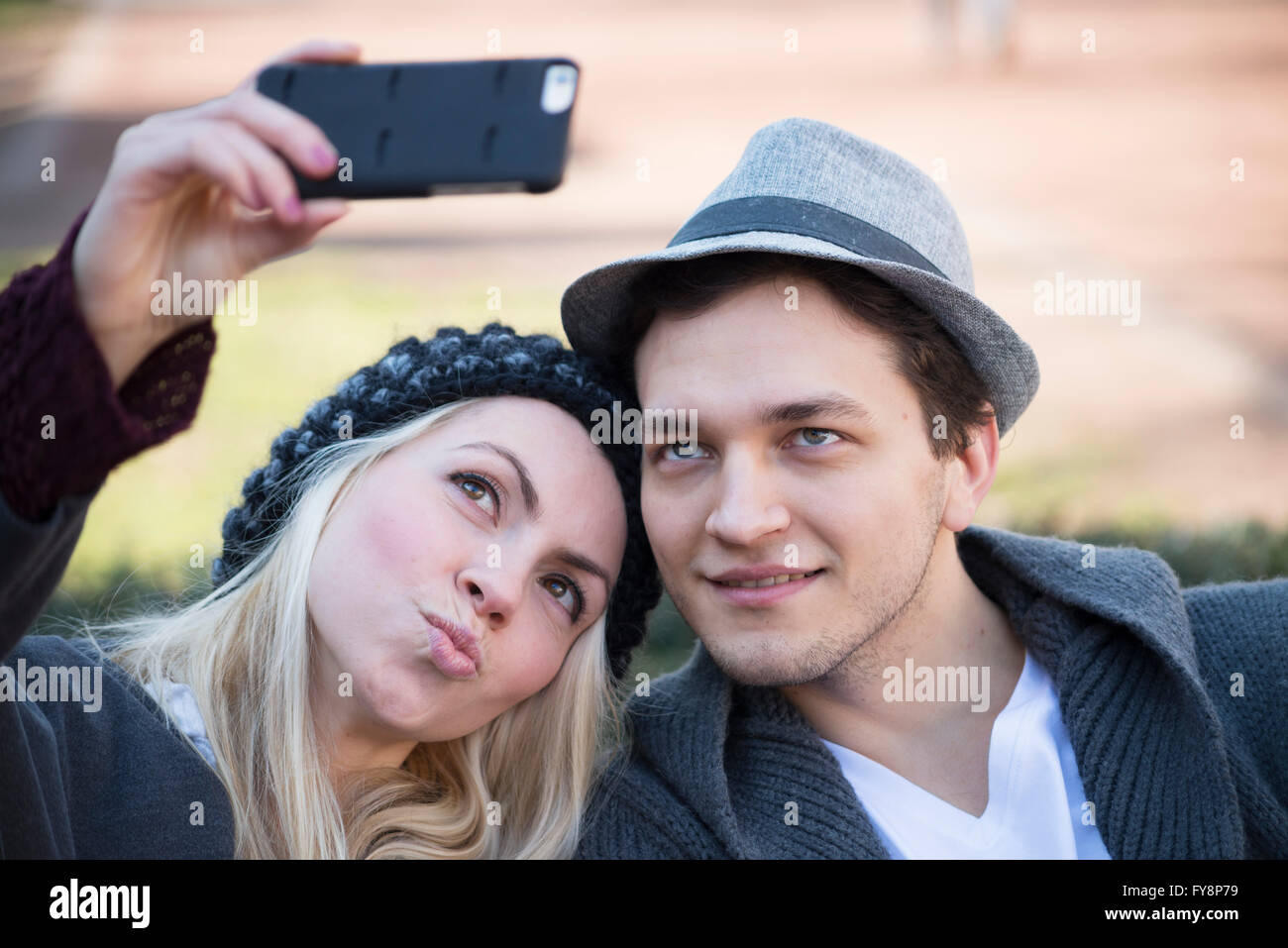 Portrait of couple in love taking selfie with smartphone Stock Photo ...