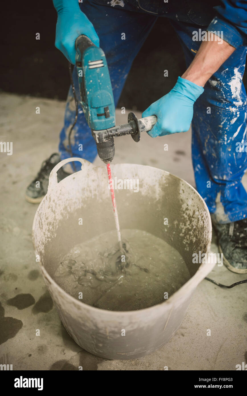 Bricklayer mixing cement in bucket Stock Photo Alamy