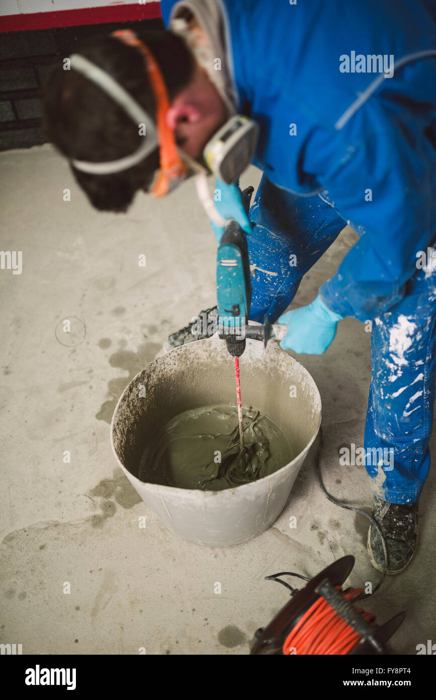 Bricklayer mixing cement in bucket Stock Photo Alamy