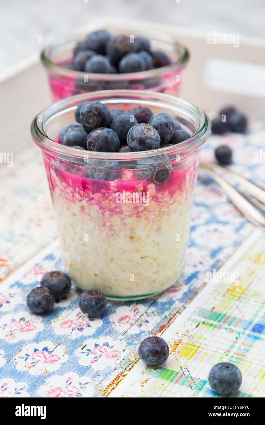 Glasses of overnight oats with blueberries and berry juice Stock Photo
