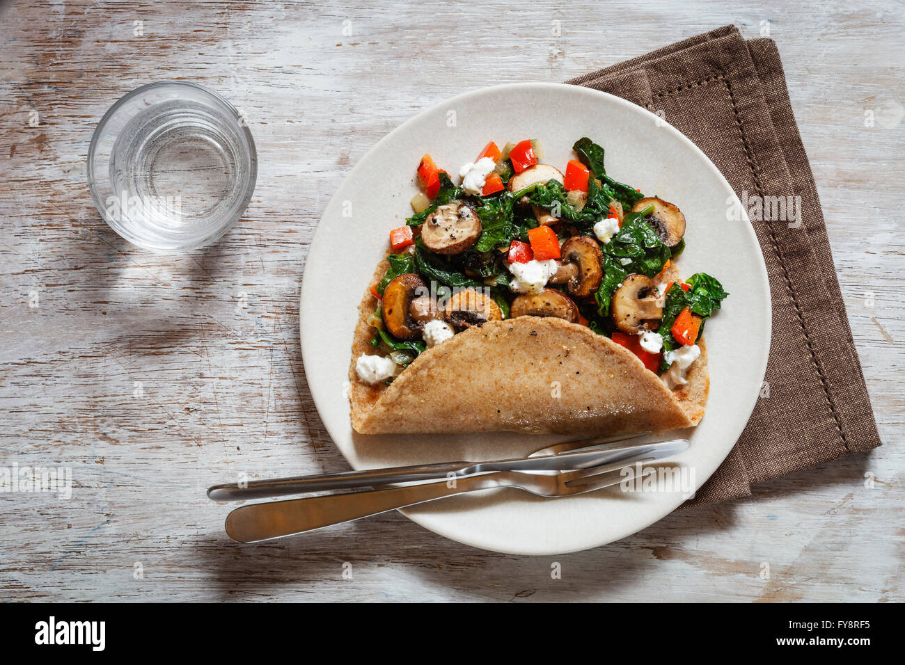 Wholemeal buckwheat spealt wheat pancake, filled with spinach, bell