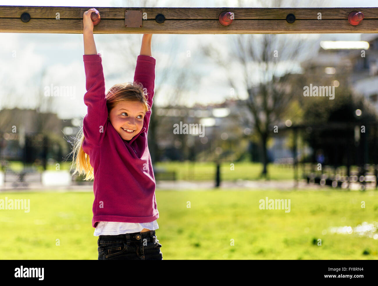 Portrait of smiling little girl playing on a playground Stock Photo - Alamy