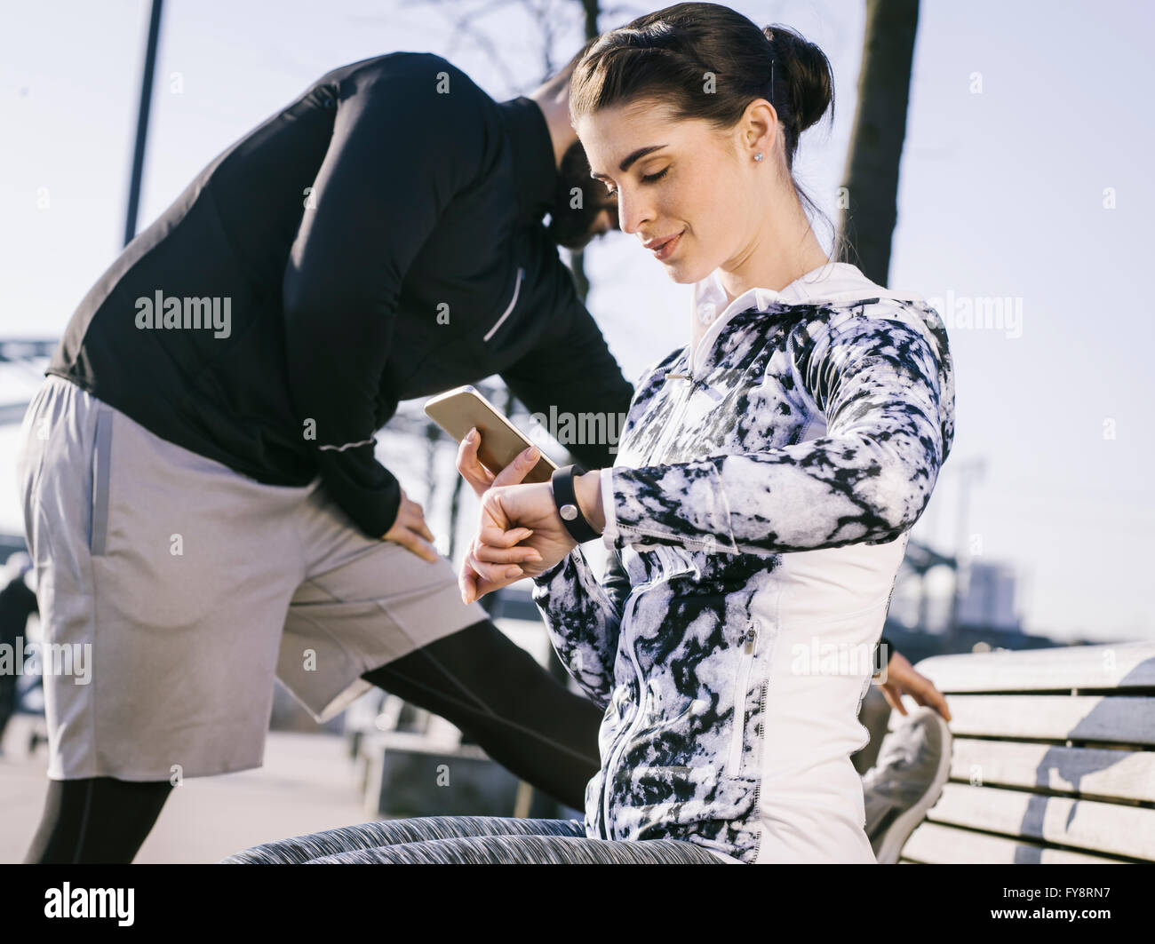 Germany, Cologne, Young couple worming up for workout in the morning Stock Photo