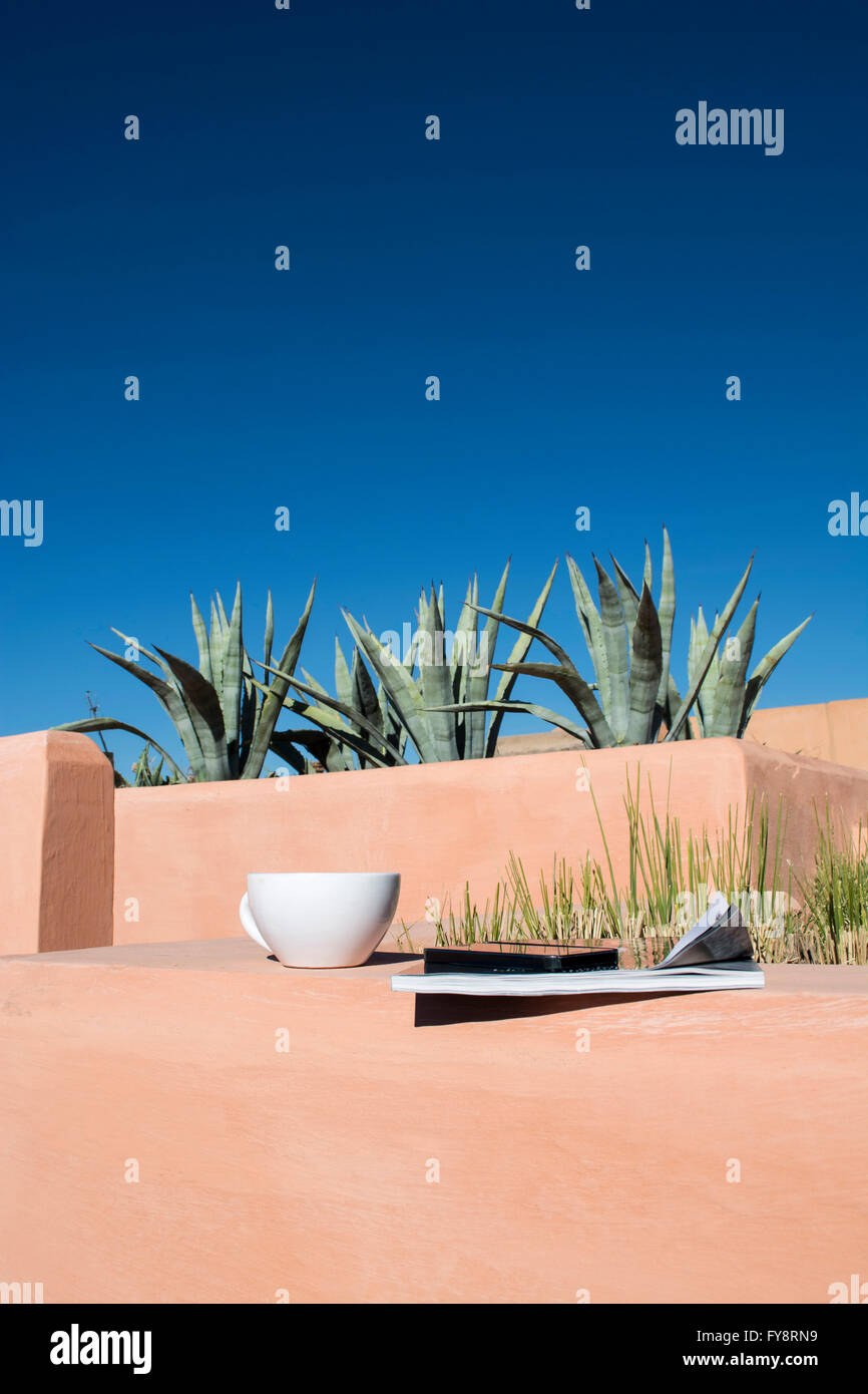 Teacup, magazine, mobile phone on roof terrace Stock Photo Alamy