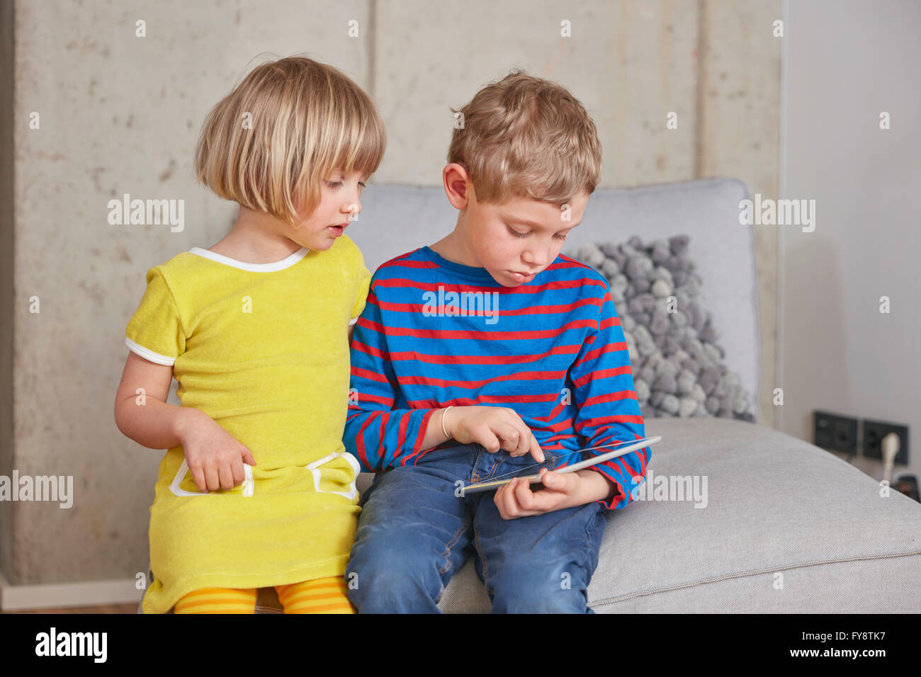 Brother and sister using digital tablet Stock Photo