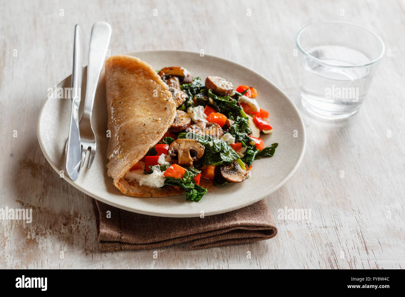 Wholemeal buckwheat spealt wheat pancake, filled with spinach, bell