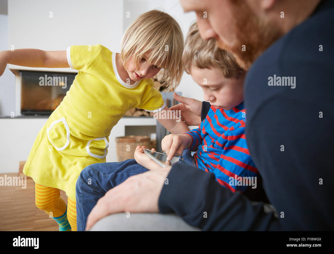 Father and two children using digital tablet Stock Photo