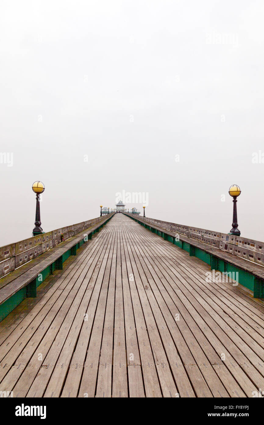 Early morning mist gives a dramatic minimalist view of the restored Victorian pier at Clevedon, North Somerset, England, UK Stock Photo