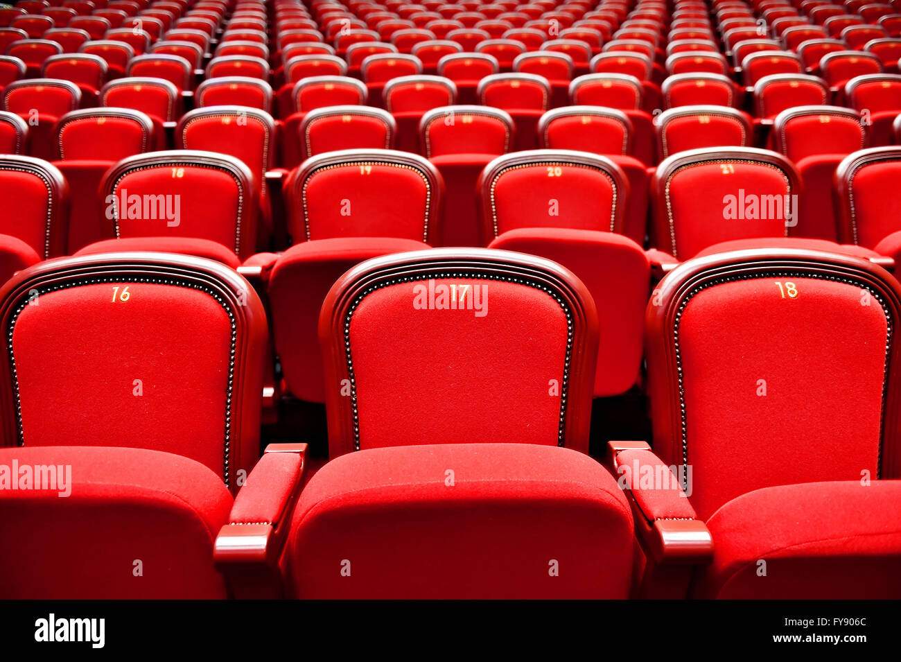 Rows of empty red velvet seats inside a theater Stock Photo - Alamy