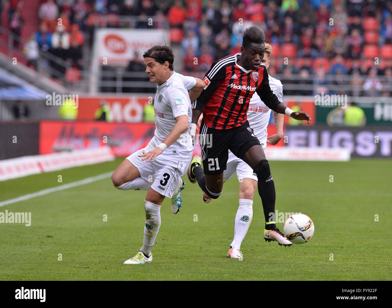 Ingolstadt, Germany. 23rd Apr, 2016. Ingolstadt's Danny da Costa (c) and Hanover's Miiko Albornoz (l.) in action during the German Bundesliga soccer match between FC Ingolstadt and Hanover 96 at Audi Sportpark in Ingolstadt, Germany, 23 April 2016. PHOTO: LUKAS BARTH/dpa (EMBARGO CONDITIONS - ATTENTION: Due to the accreditation guidlines, the DFL only permits the publication and utilisation of up to 15 pictures per match on the internet and in online media during the match.) Credit:  dpa/Alamy Live News Stock Photo