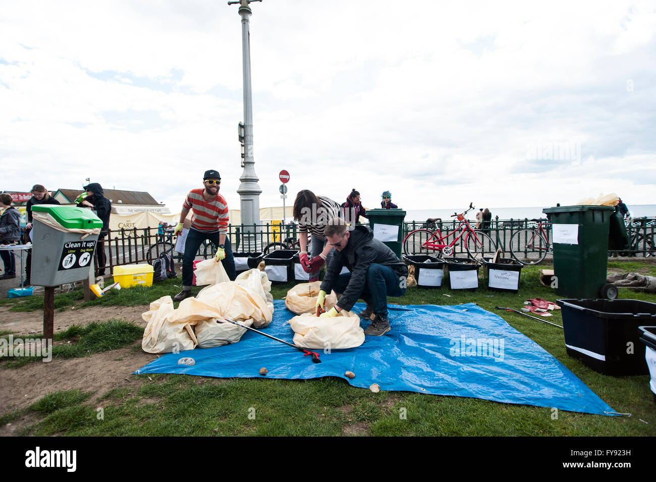 Brighton, UK. Saturday 23 April 2016. The Big Spring Beach Clean, organised by Surfers Against Sewage, Zero Waste Brighton and The Deans Beach & Environment Volunteers, have seen over 150 people turn out to partake in their biannual beach clean-up. One of the issues highlighted this year are the deposits of palm oil and paraffin by ships in the English Channel. The waste, as seen in pink bucket, has washed up on Sussex beaches and it's ingestion is harmful to dogs and children. Credit:  Francesca Moore/Alamy Live News Stock Photo