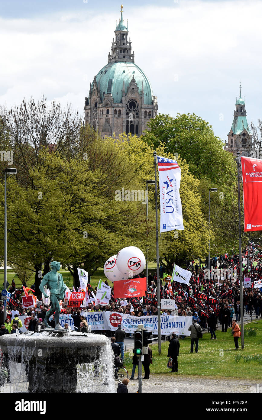 Hanover, Germany. 23rd Apr, 2016. Activists carry flags and banners during a rally against the controversial transatlantic trade agreement TTIP in Hanover, Germany, 23 April 2016. Organisations for environment and consumer protection as well as for third world relief fear sinking ecological and social standards in Europe and that the agreement gives more power to big corportations. US-President Obama visits the Hanover Messe fair from 24 to 25 April 2016 in Hanover. Photo: Holger Hollemann/dpa/Alamy Live News Stock Photo