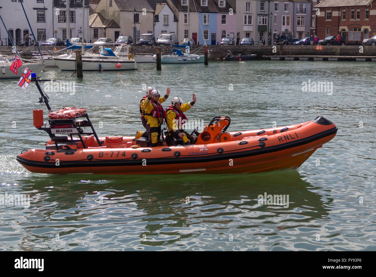 Weymouth, England. 23 April 2016. Queen's 90th Birthday Floating Tribute. RnLI Lifeboat Dinghy People Waving. Credit:  Frances Underwood/Alamy Live News Stock Photo