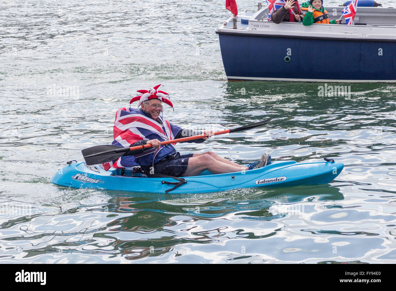 Weymouth, England. 23 April 2016. Queen's 90th Birthday Floating Tribute. Man in blue canoe wearing Union Flag. Credit:  Frances Underwood/Alamy Live News Stock Photo