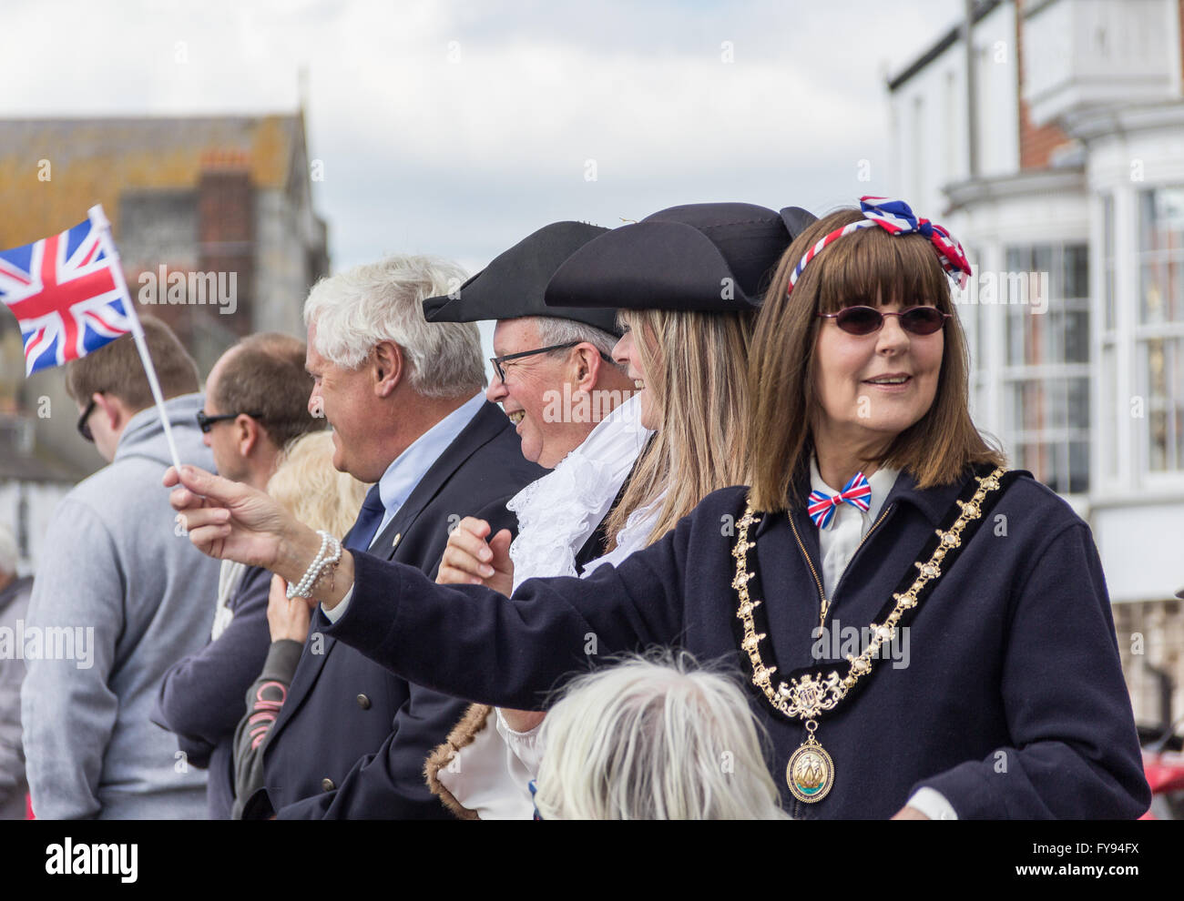 Weymouth, England. 23 April 2016. Queen's 90th Birthday Floating Tribute. Deputy Mayor of Weymouth and Portland waving flag. Credit:  Frances Underwood/Alamy Live News Stock Photo