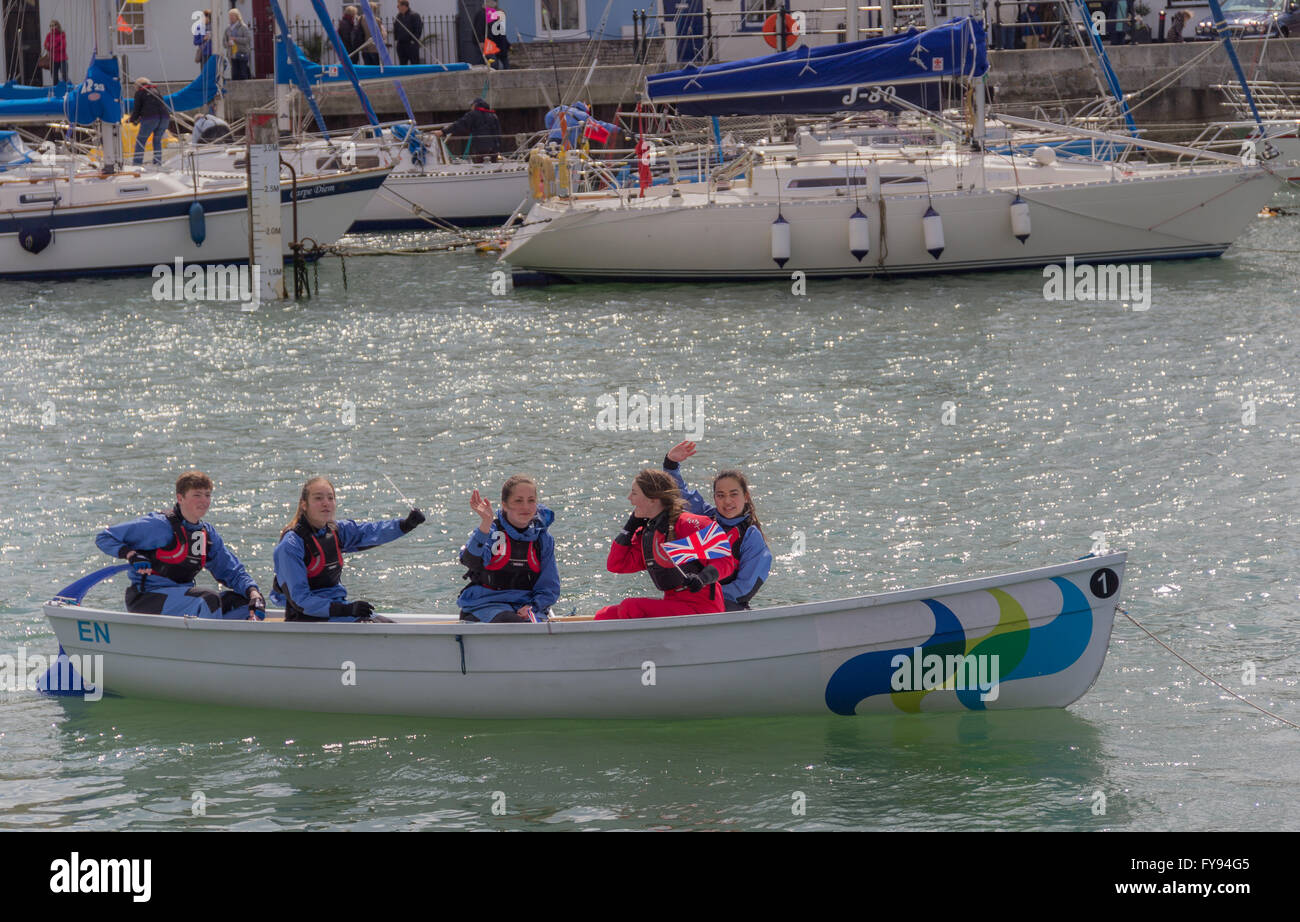 Weymouth, England. 23 April 2016. Queen's 90th Birthday Floating Tribute. Young people in small boat, waving. Credit:  Frances Underwood/Alamy Live News Stock Photo
