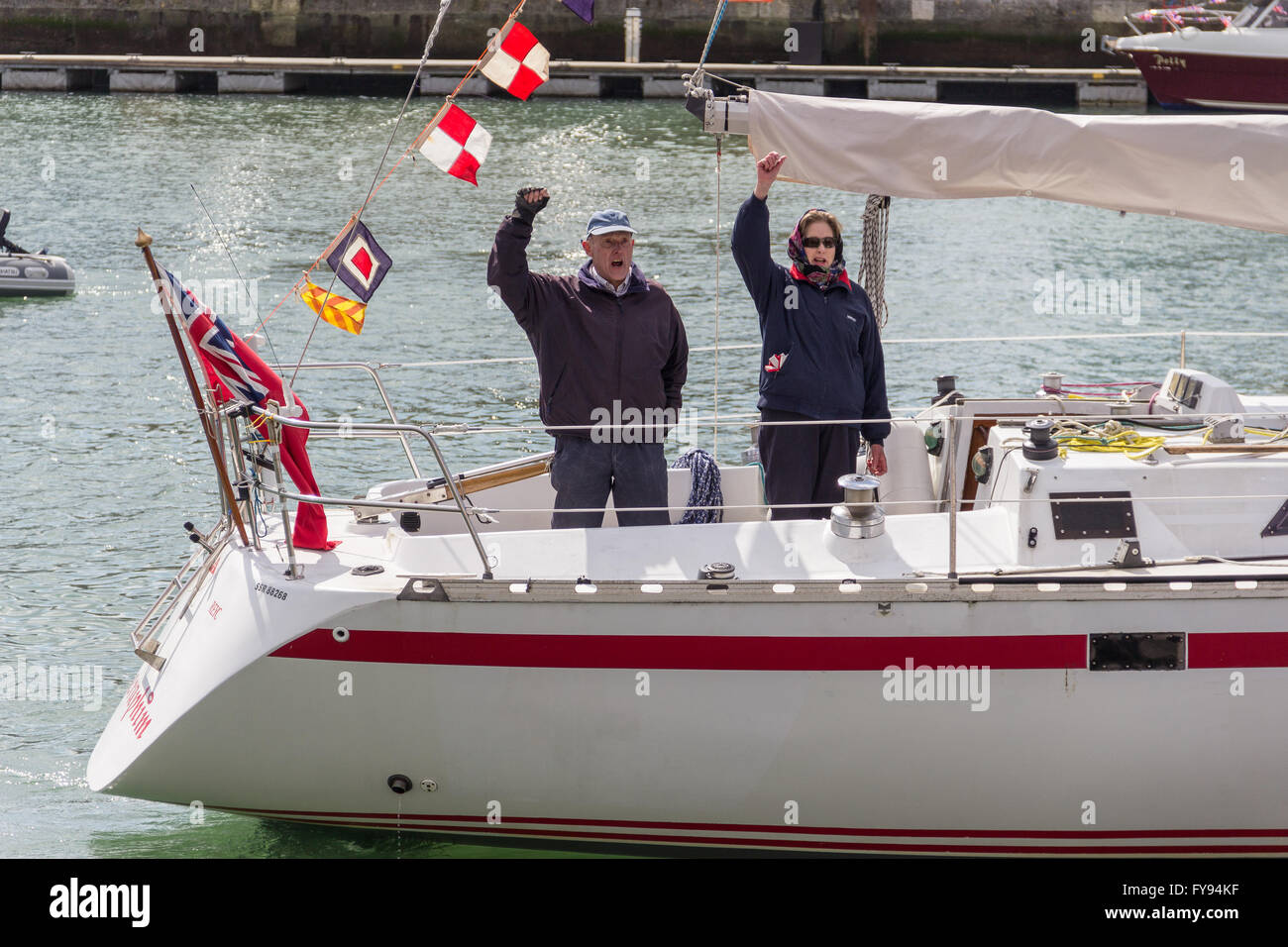Weymouth, England. 23 April 2016. Queen's 90th Birthday Floating Tribute. People cheering on white boat. Credit:  Frances Underwood/Alamy Live News Stock Photo