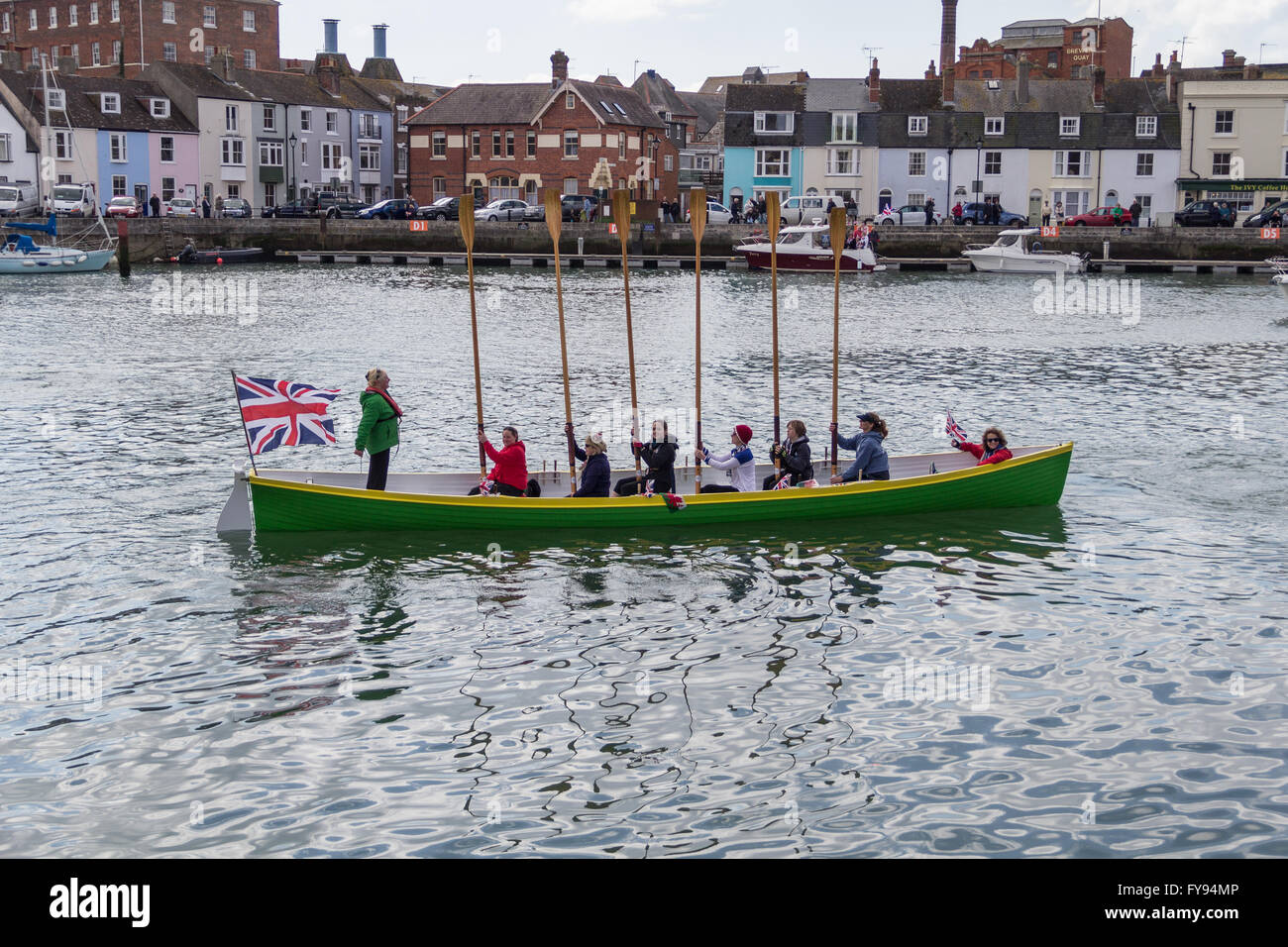 Weymouth, England. 23 April 2016. Queen's 90th Birthday Floating Tribute. Rowing boat, rowers saluting. Credit:  Frances Underwood/Alamy Live News Stock Photo