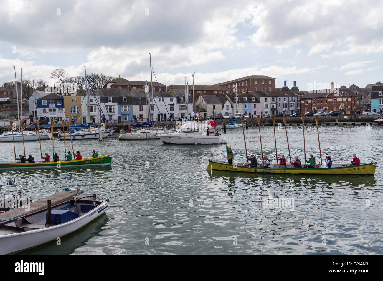 Weymouth, England. 23 April 2016. Queen's 90th Birthday Floating Tribute. Two rowing boats, rowers saluting. Credit:  Frances Underwood/Alamy Live News Stock Photo