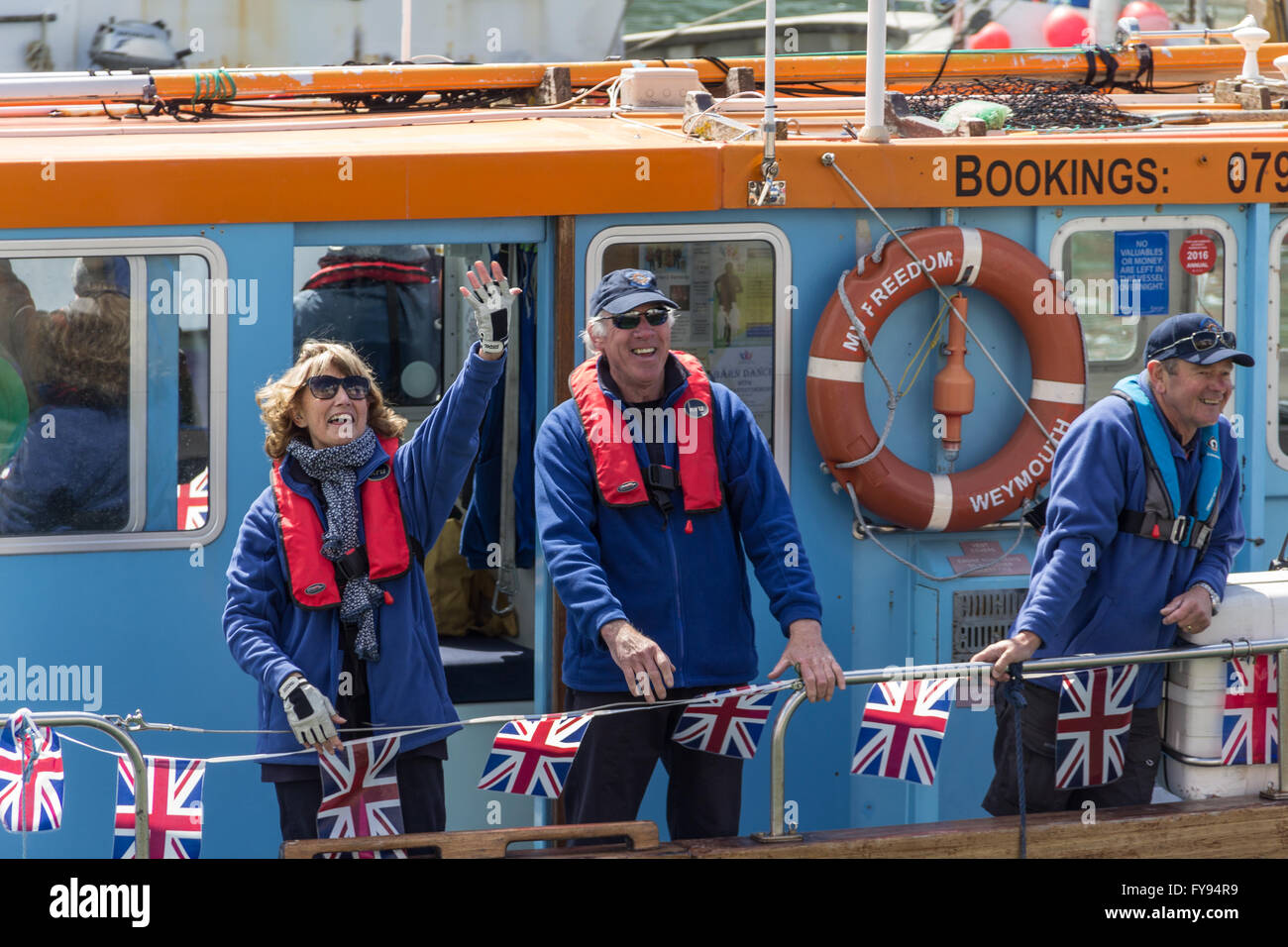 Weymouth, England. 23 April 2016. Queen's 90th Birthday Floating Tribute. People waving from disabled boat, MV Freedom. Credit:  Frances Underwood/Alamy Live News Stock Photo