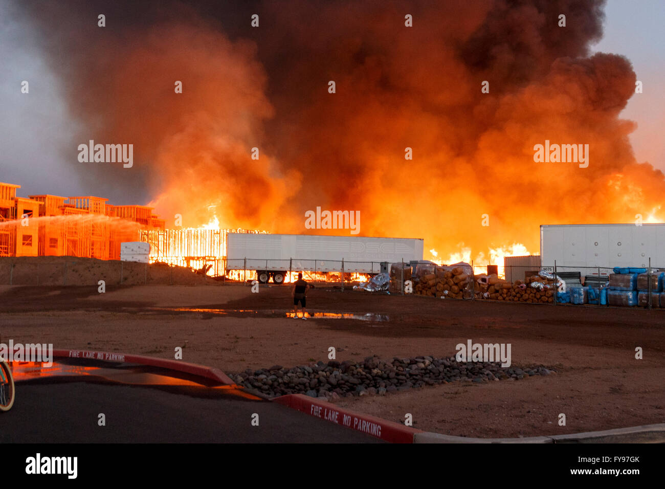 Gilbert, Arizona, USA. 23th April, 2016. Construction Site Fire burns as firefighters battle the blaze. Credit:  Jennifer Mack/Alamy Live News Stock Photo