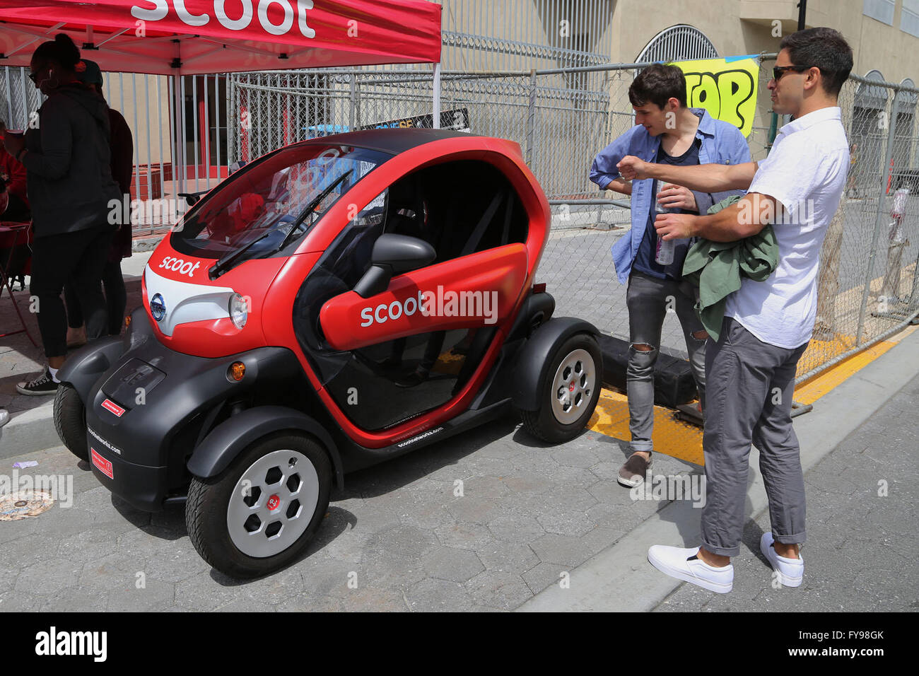 San Francisco, USA. 23rd Apr, 2016. Two Earth Day event visitors look at an electric vehicle in downtown San Francisco, the United States, on April 23, 2016. The annual Earth Day San Francisco Street Fest was held in San Francisco on Saturday. Environmental activists brought the public an educational and entertaining green event to help raise their ecological awareness. © Liu Yilin/Xinhua/Alamy Live News Stock Photo