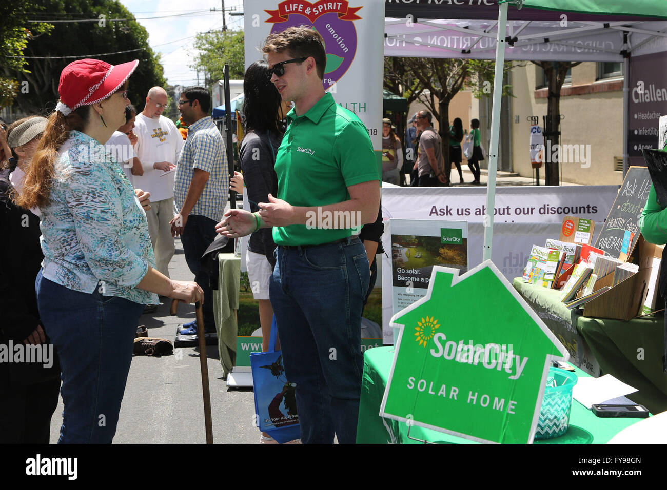San Francisco, USA. 23rd Apr, 2016. An Earth Day event worker (R) educates an visitor about solar energy in downtown San Francisco, the United States, on April 23, 2016. The annual Earth Day San Francisco Street Fest was held in San Francisco on Saturday. Environmental activists brought the public an educational and entertaining green event to help raise their ecological awareness. © Liu Yilin/Xinhua/Alamy Live News Stock Photo