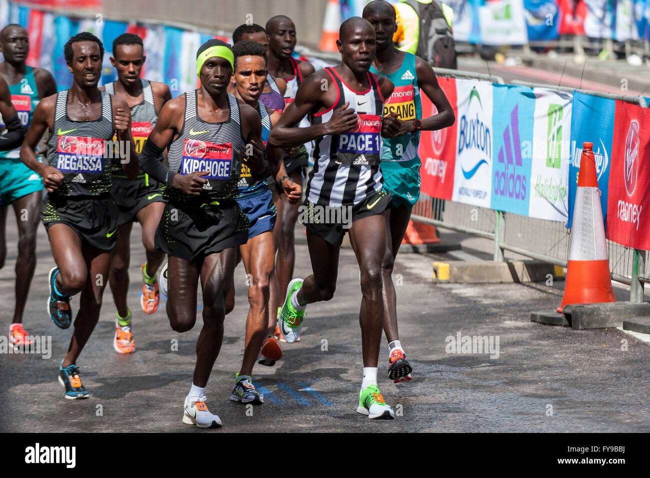 London, UK. 24 April 2016. The winner of the Virgin Money London Marathon  elite men's race, Eliud Kipchoge (Kenya), (black vest, yellow headband), is  seen with other elite men passing through mile