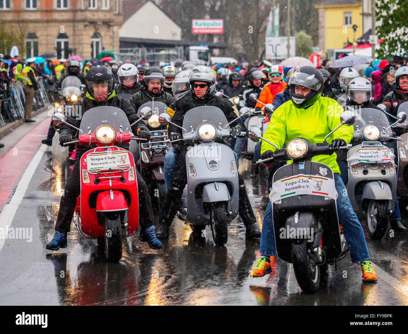 Motorcyclists on Vespars drive in a procession through the town of Kulmbach, Germany, 24 April 2016. More than 1,000 motorcycle enthusiasts have come toegther for the traditional 16th 'Motorrad-Sternfahrt' (Motorcycle procession). Photo: Nicolas Armer/dpa Stock Photo