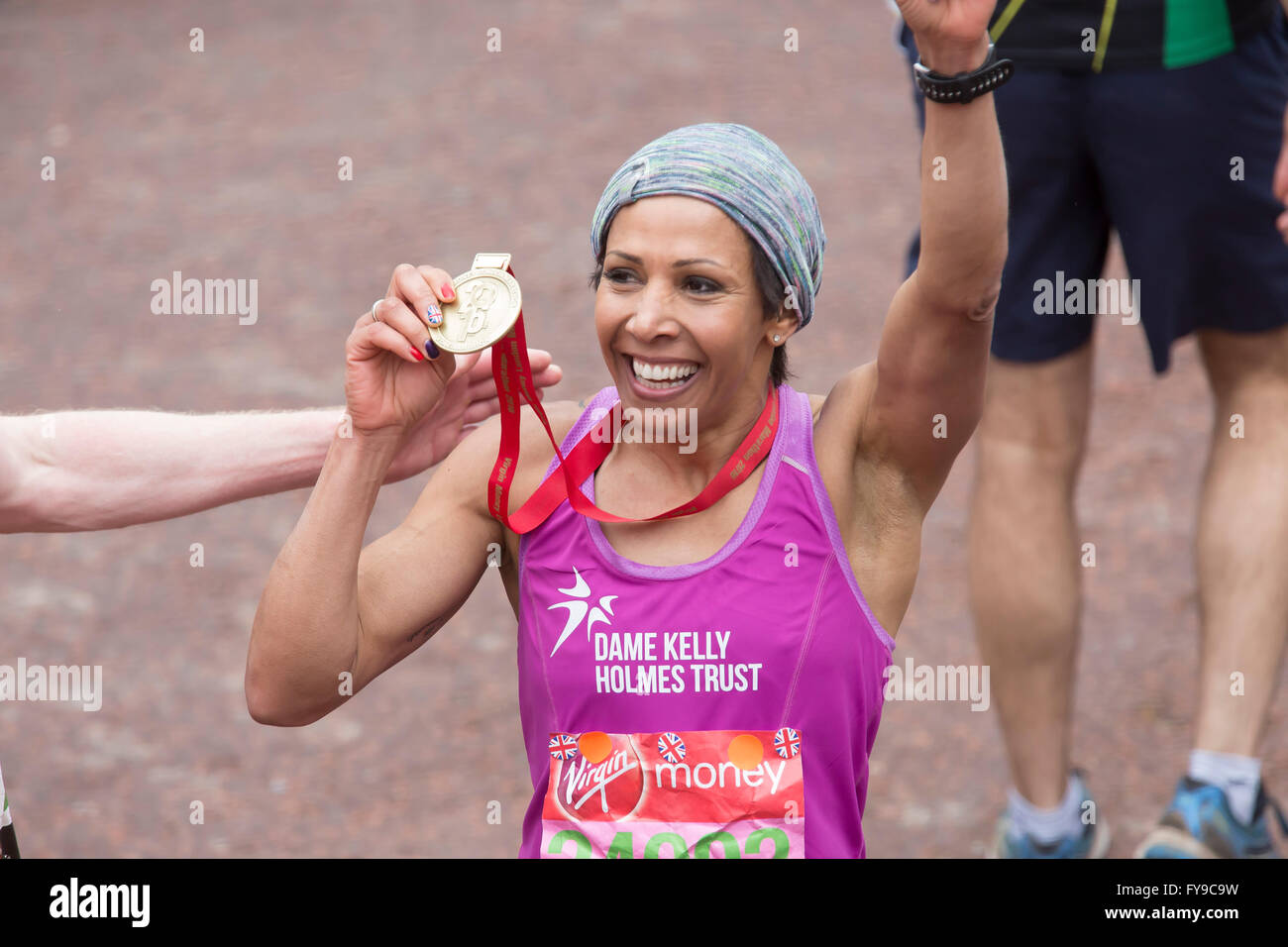 London,UK,24th April 2016,Dame Kelly Holmes holds up her medal proudly after completing the Virgin London Marathon 201 Credit: Keith Larby/Alamy Live News Stock Photo