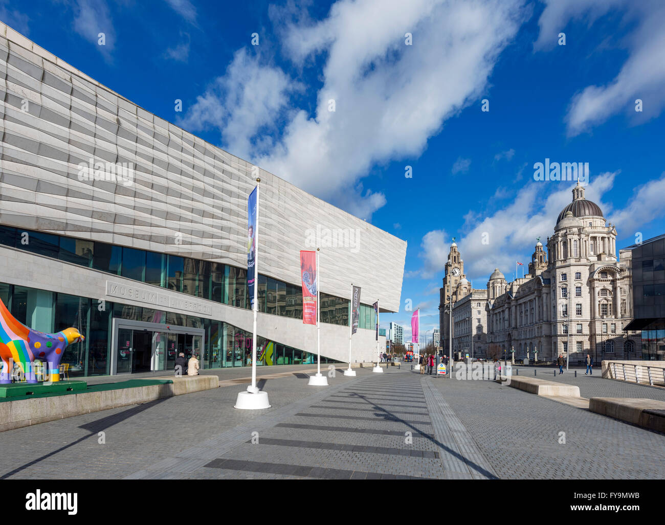 Entrance to the Museum of Liverpool with the Three Graces behind, Pier Head, Liverpool, Merseyside, England, UK Stock Photo