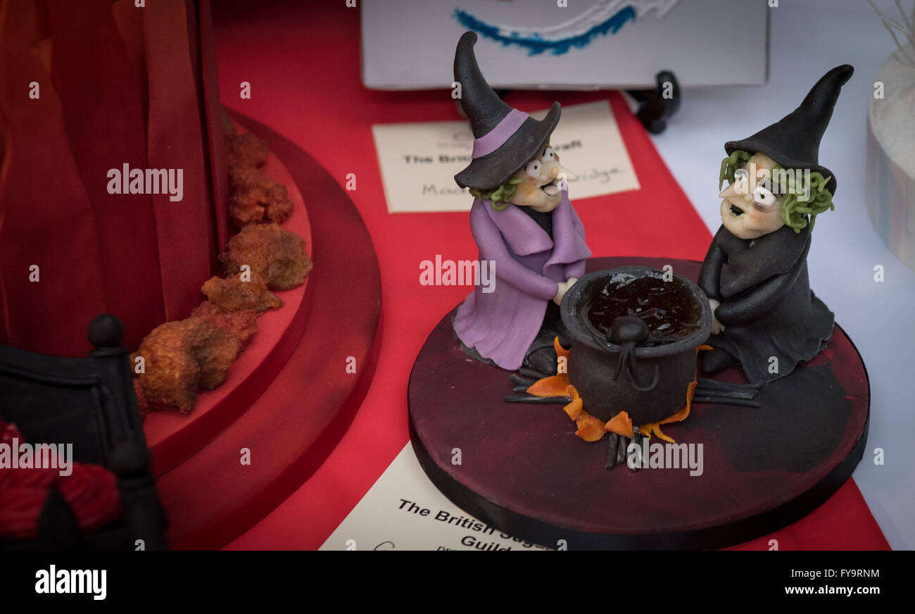 Halloween two witches by the cauldron at Cake International – The Sugarcraft, Cake Decorating and Baking Show in London Stock Photo